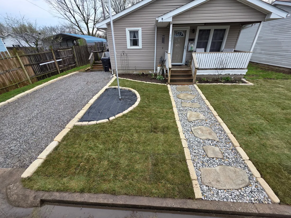 Backyard path with fresh gravel beds and clean edging leading from a porch